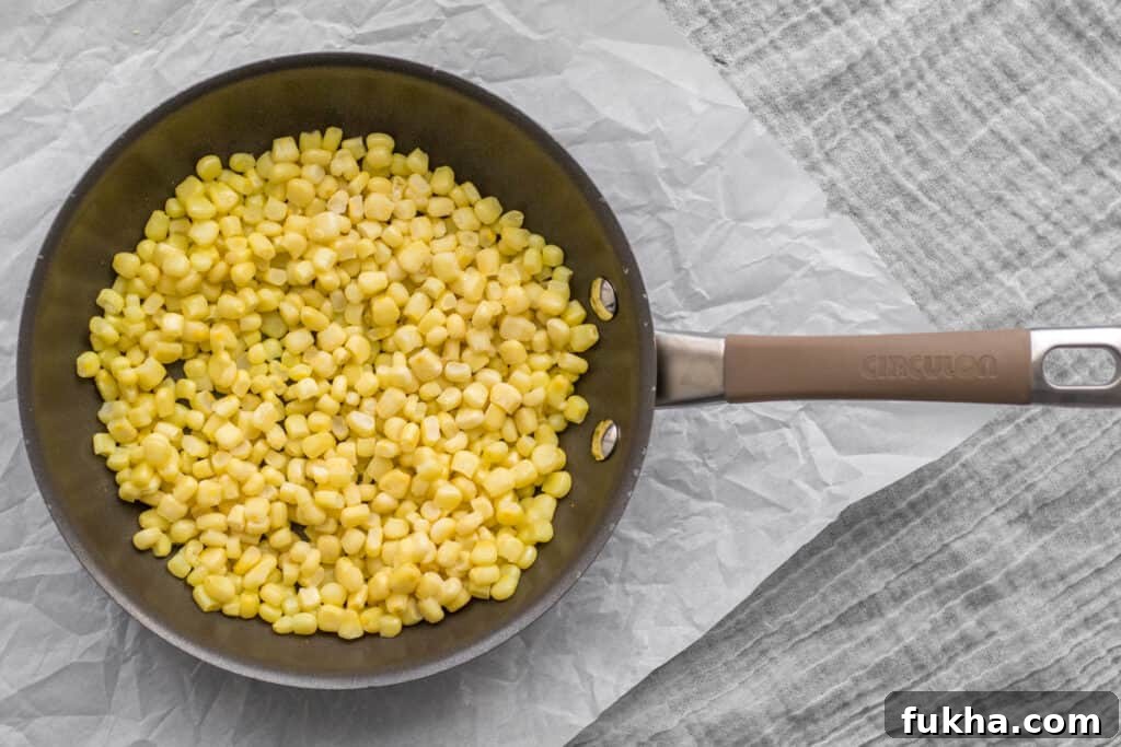 Smoky Charred Corn on the Cob Recipe 4 frozen corn in a frying pan