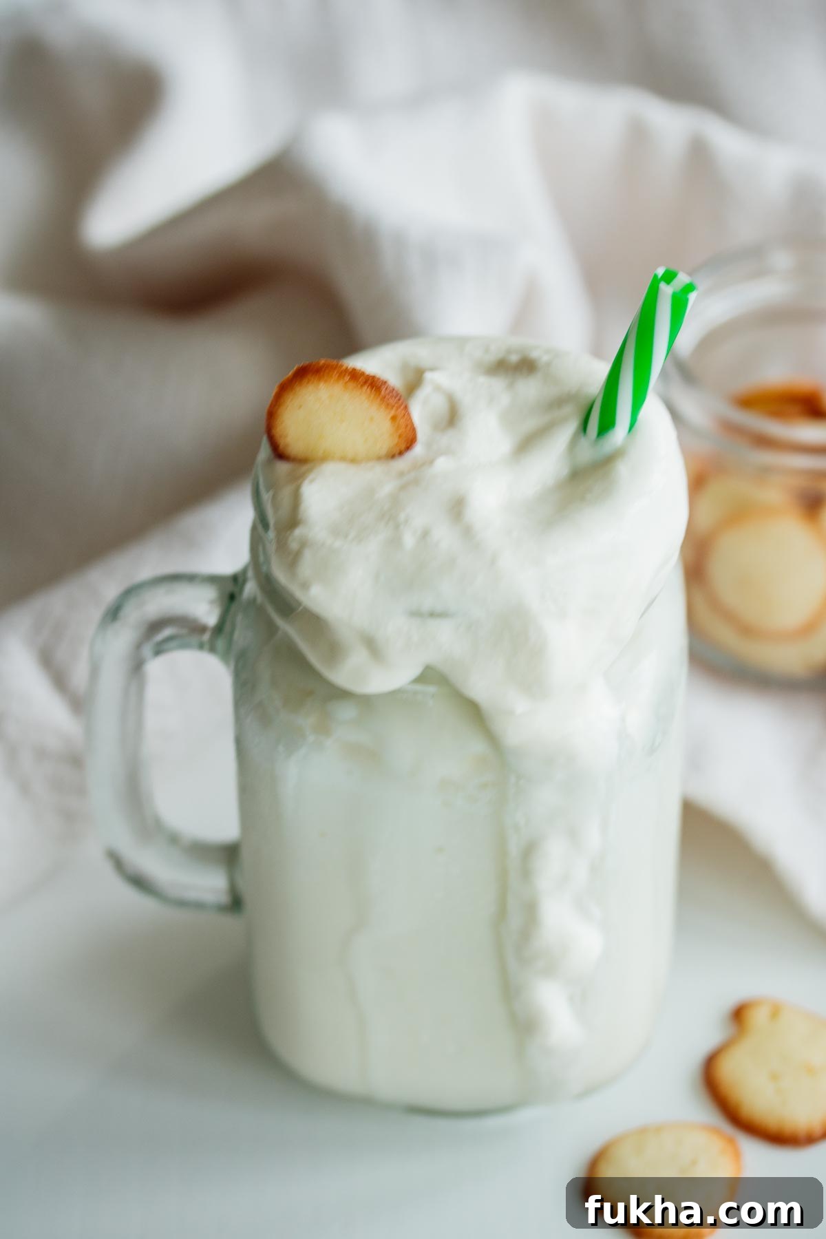 A Starbucks vanilla frappuccino in a tall glass mug.