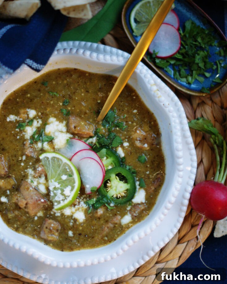 A bowl of Mexican pork stew made with green chiles, tomatillos and cilantro called chile verde.