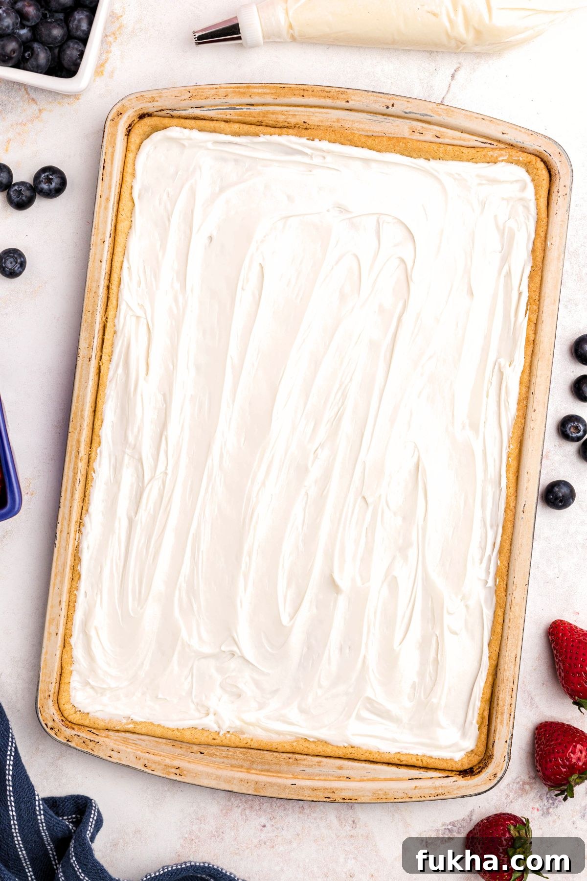 Fourth of July American Flag Fruit Pizza Recipe 5 Large sugar cookie baked in cookie sheet, then frosting on top with white frosting.