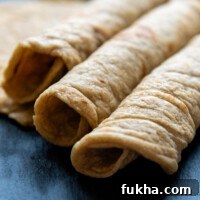 Three Oat Flour Tortillas rolled next to each other.