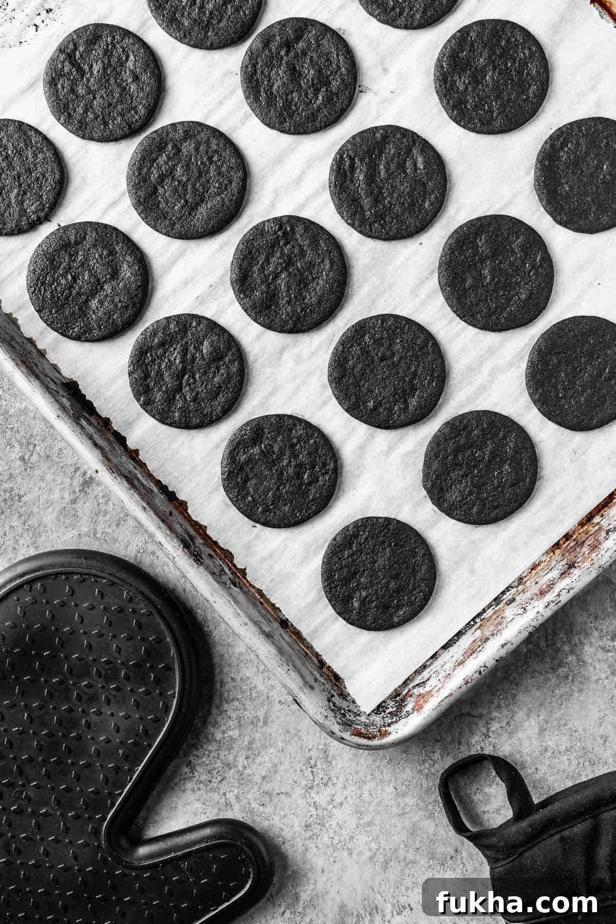 Crispy Homemade Chocolate Wafer Cookies Recipe 12 Baked chocolate wafer cookies on a parchment lined baking sheet.