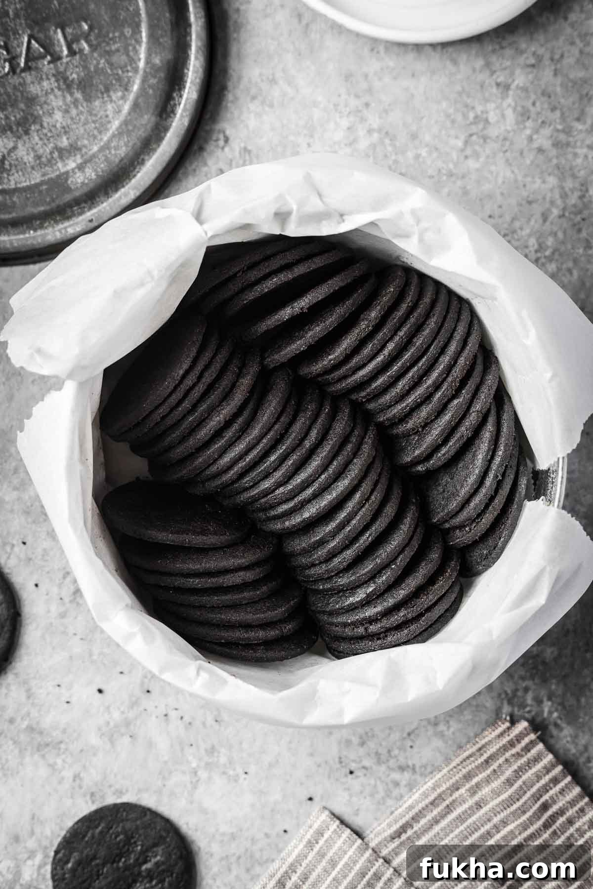 Crispy Homemade Chocolate Wafer Cookies Recipe 15 A vintage cookie tin full of thin round dark chocolate cookies.