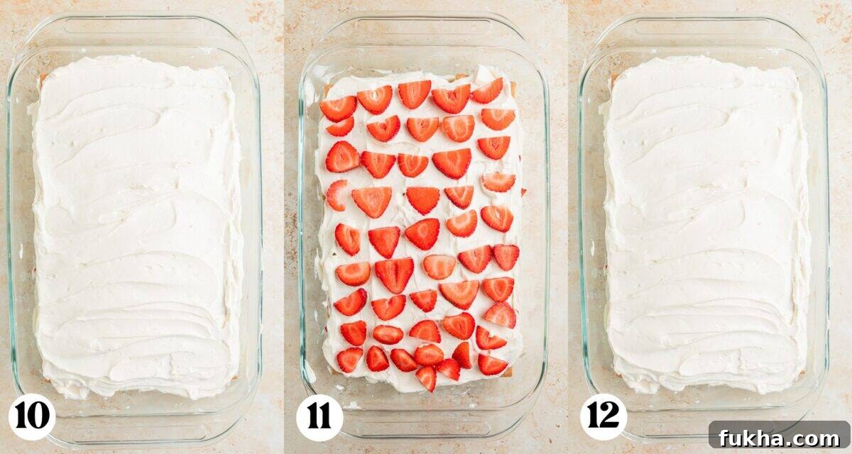 Whipped cream spread over graham crackers and then strawberries added on top and another layer of whipped cream.