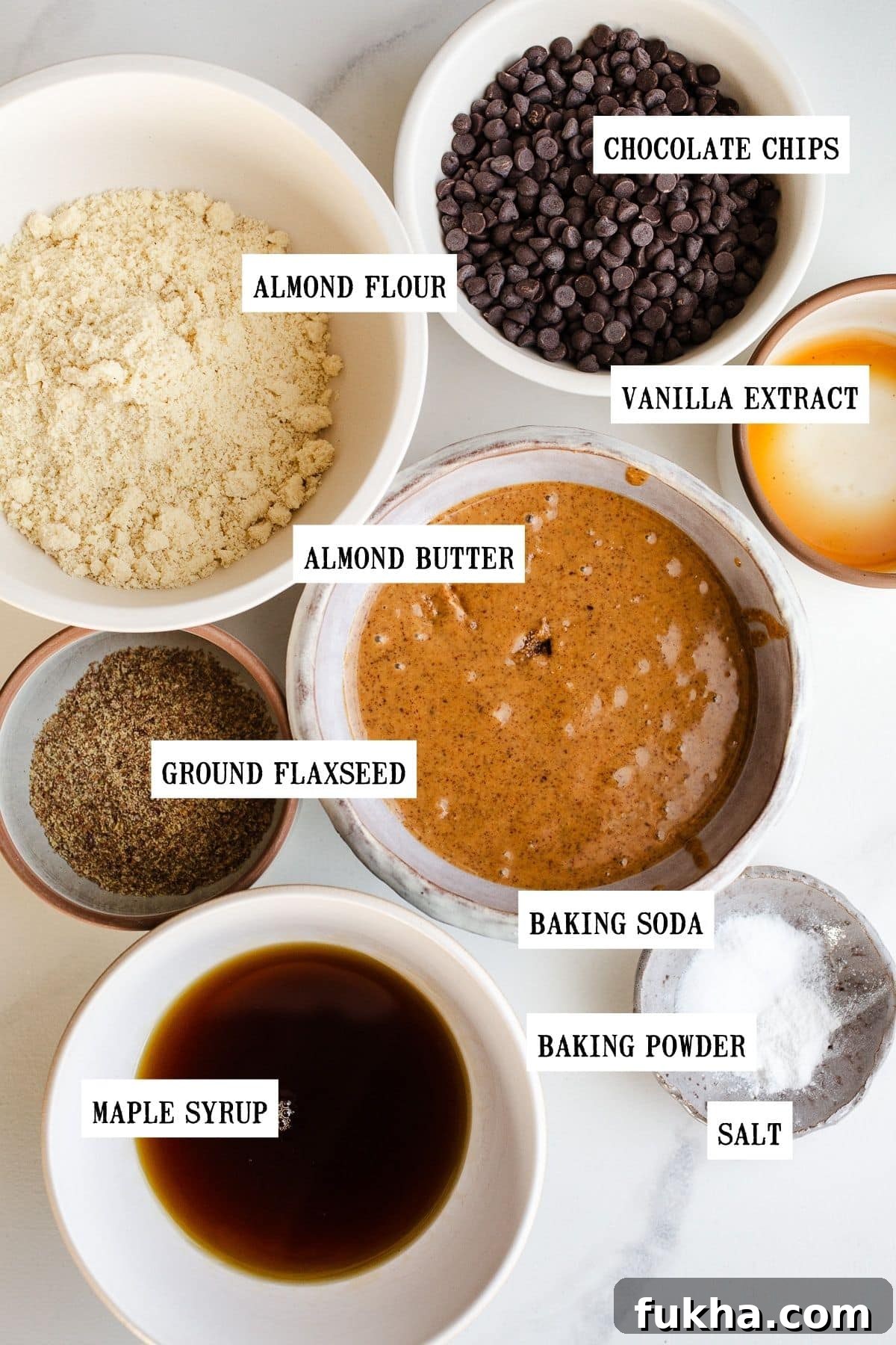 Ingredients to make chocolate chip cookies in small bowls.