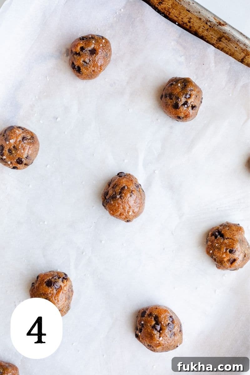 Cookie dough balls on a baking sheet.