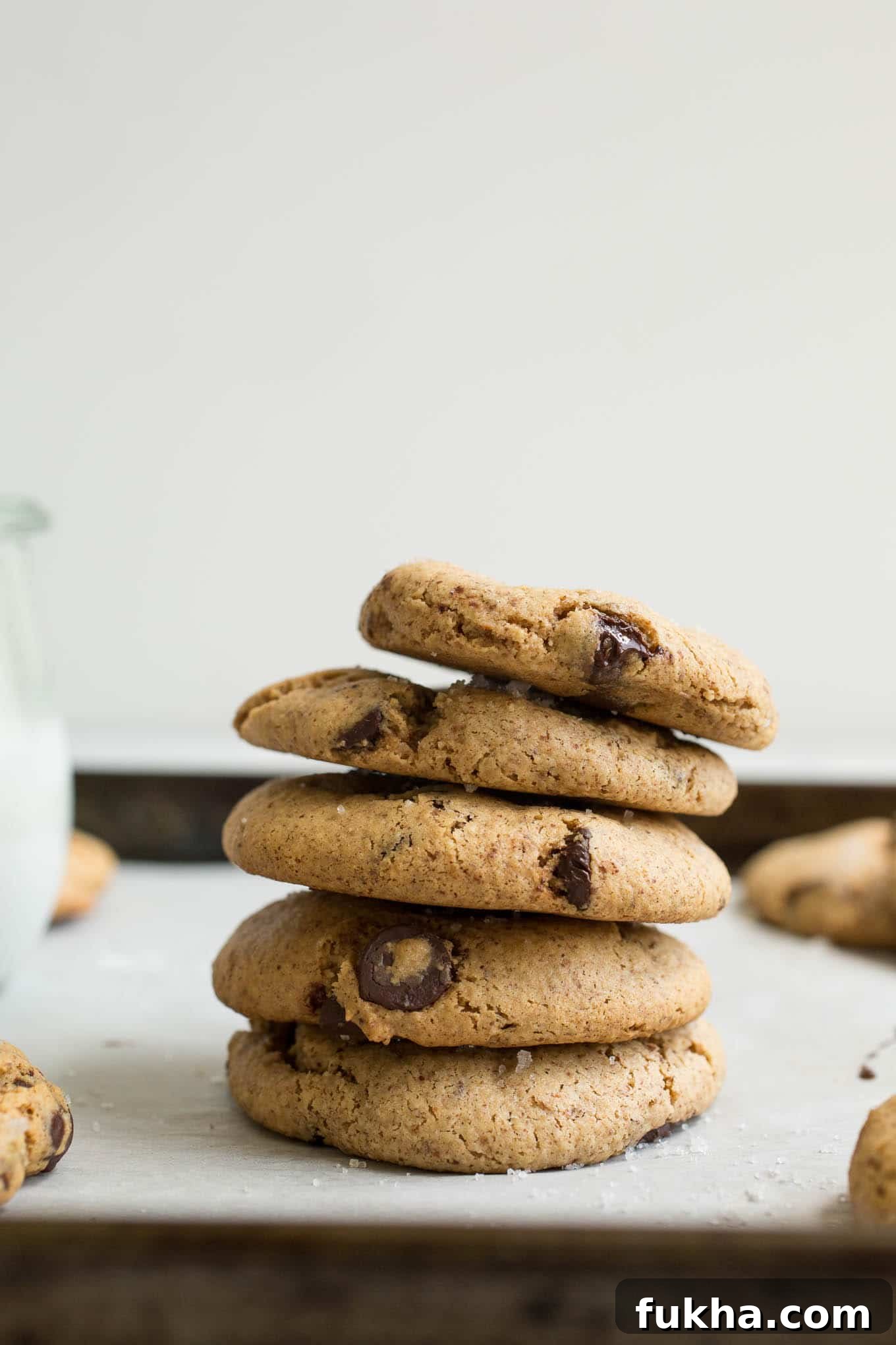 Cookies stacked on a baking sheet.