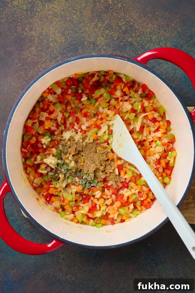 A soup pot with sautéed aromatics and spices