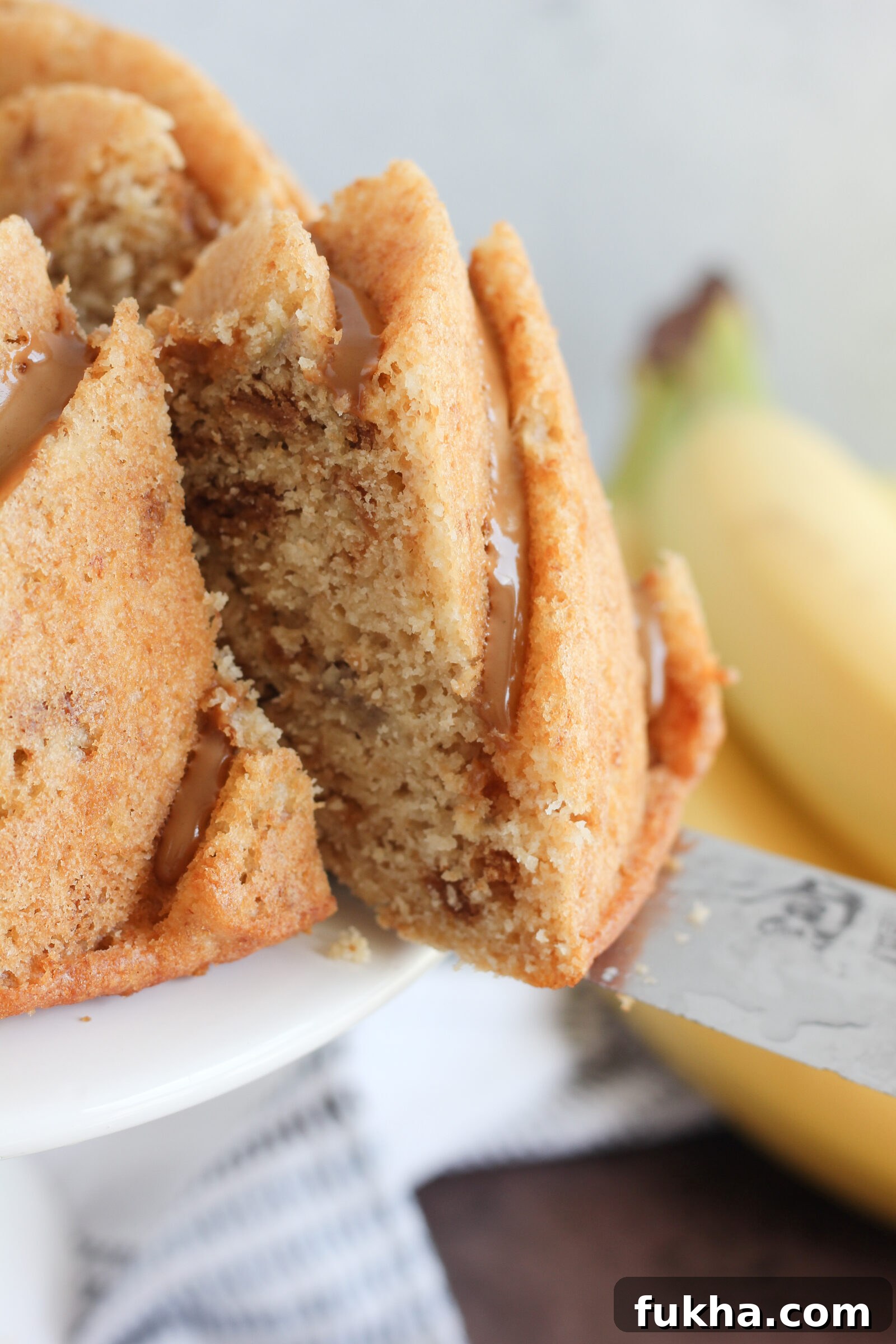 Banana Biscoff Bundt Cake with Cookie Butter Glaze 7 Slice of banana biscoff bundt cake on plate