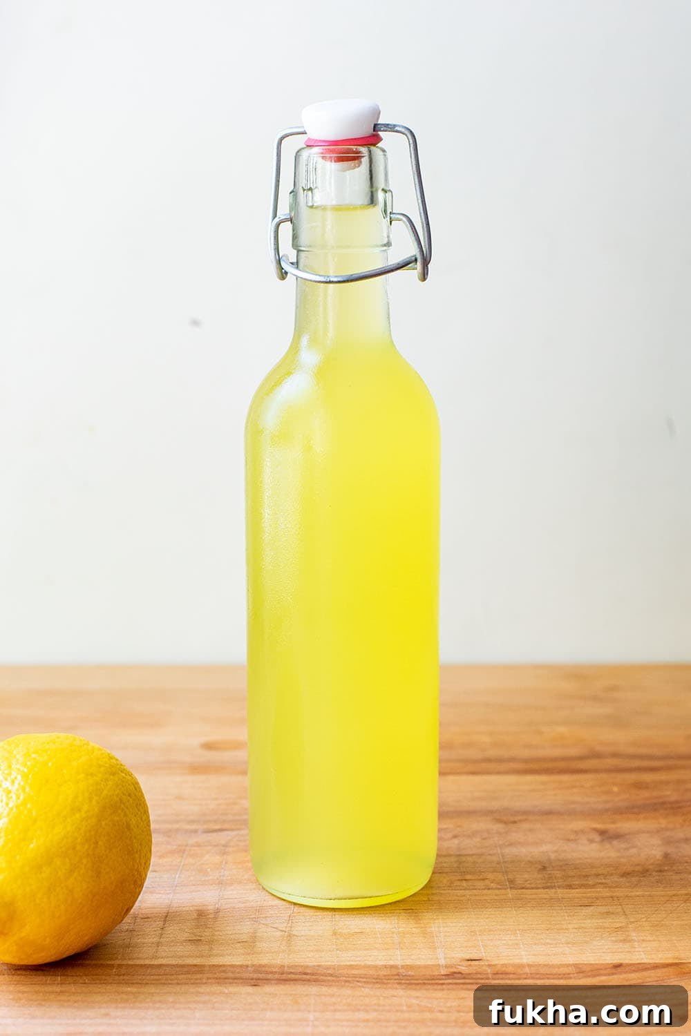 Finished, chilled limoncello in a glass swing top bottle.