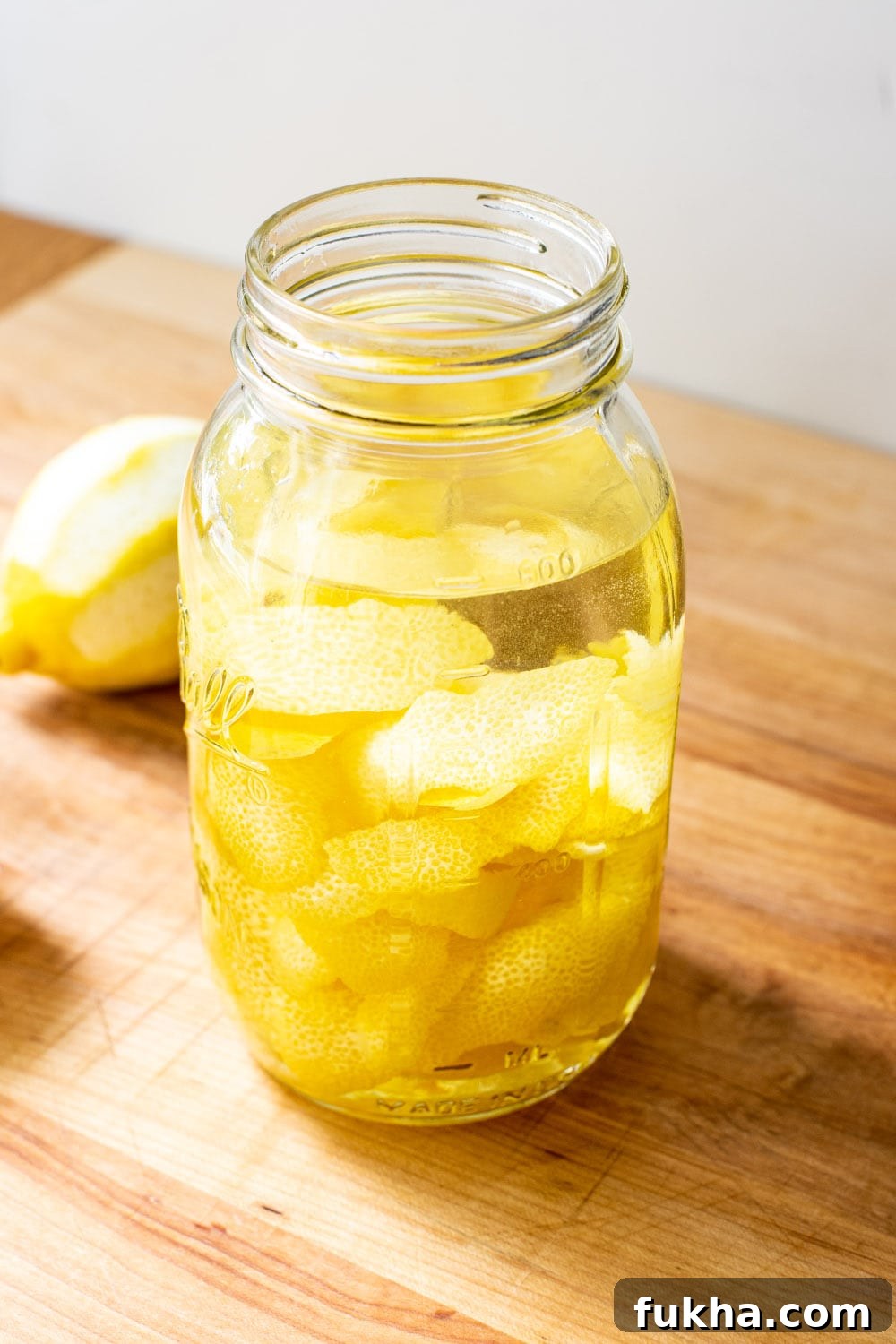 Lemon peels soaking in a mason jar filled with Everclear.