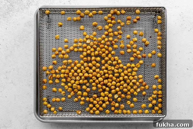 Air fried chickpeas cooling in the air fryer basket.