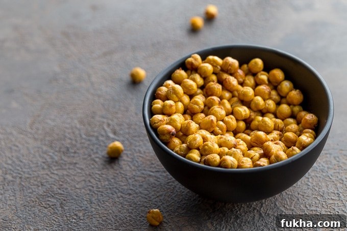 Air fryer chickpeas in a black bowl on a grey surface.