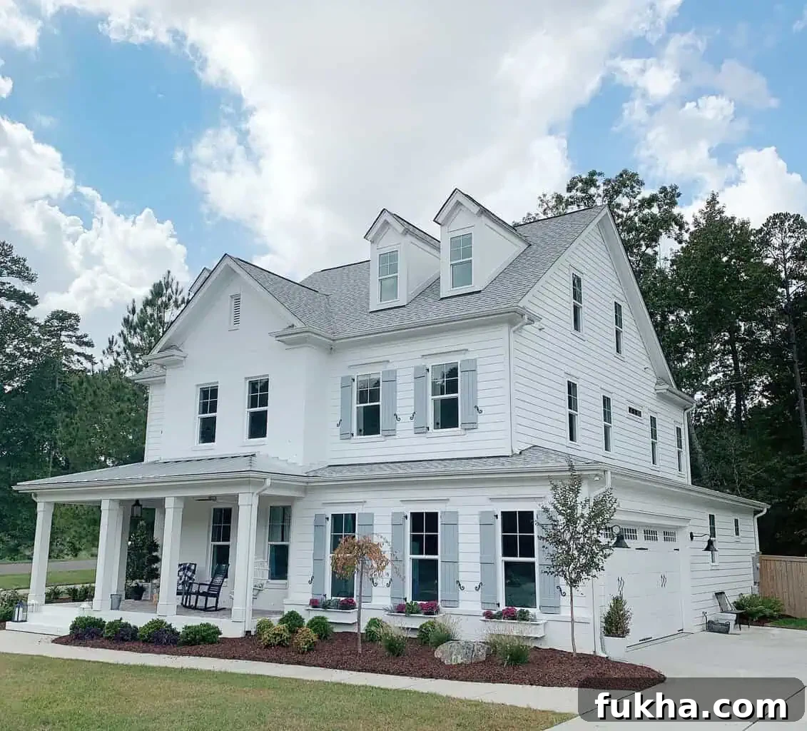 large house with 3 real and Artificial Window Box Flowers
