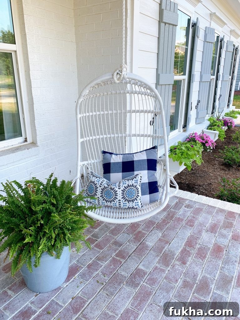 white hanging outdoor chair on a porch
