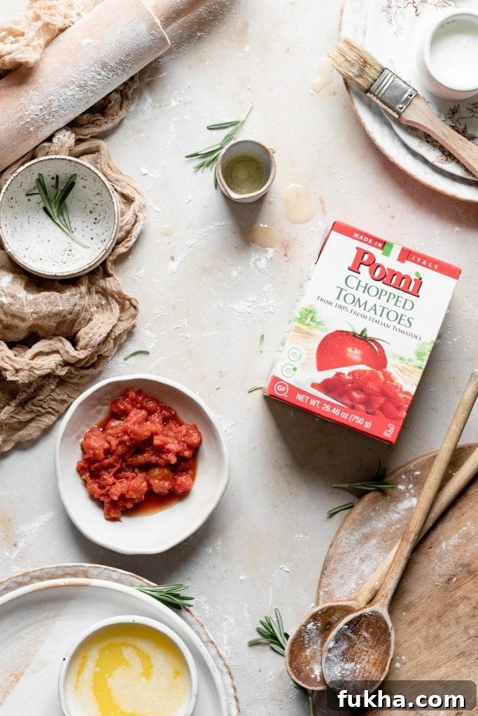 Chopped tomatoes on table with baking utensils.