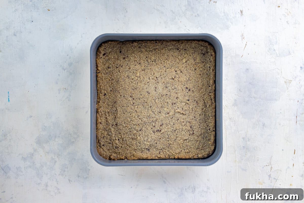 Baked almond flour crust in square pan.