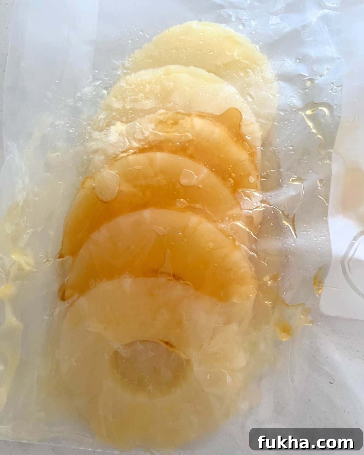 Marinated grilled pineapple in a resealable bag.