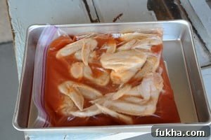Wings marinating in beer and hot sauce