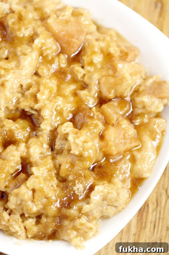 Overnight Crockpot Apple Oatmeal recipe with tangy apples, nutty oats, and sweet butter and powdered sugar glaze is a perfect overnight make ahead breakfast recipe for Fall and the holidays.