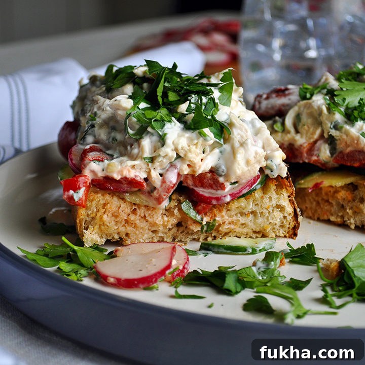 Open face Chicken salad sandwiches with tarragon, capers, roasted red peppers, radishes, and cucumbers.