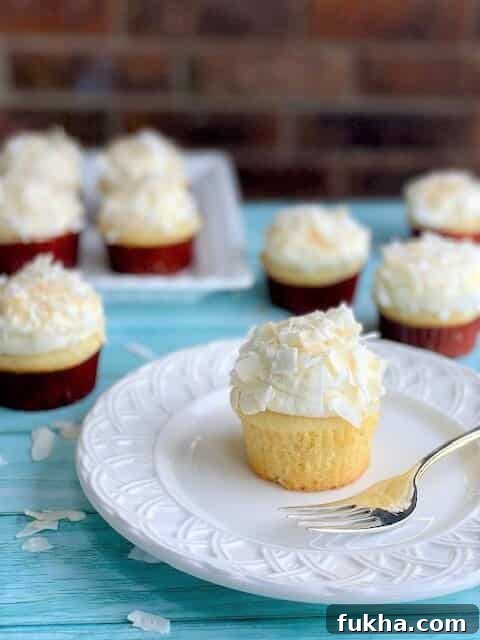 Coconut Cupcake with whipped cream frosting on a plate