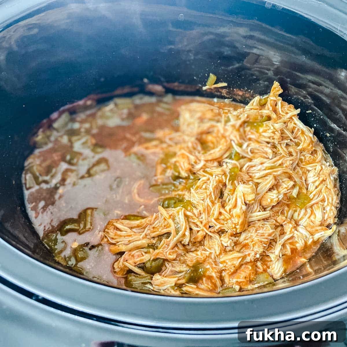 Slow Cooker Shredded Chicken Enchiladas 9 Shredded chicken is added back to the crockpot.