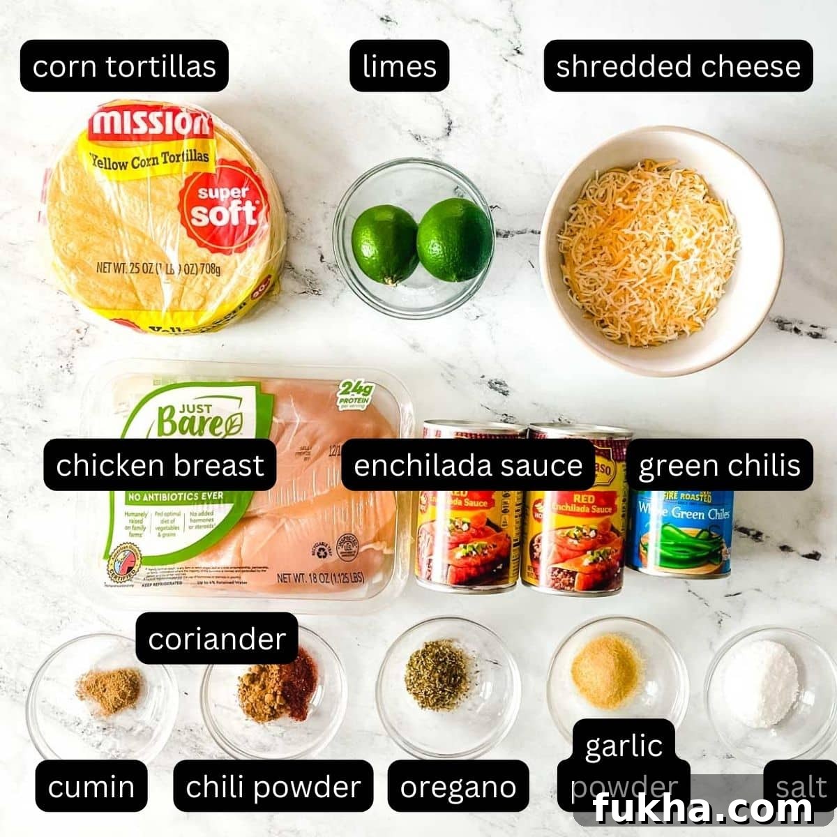 Slow Cooker Shredded Chicken Enchiladas 3 The labeled ingredients for chicken slow cooker enchiladas are shown on a white marble counter.