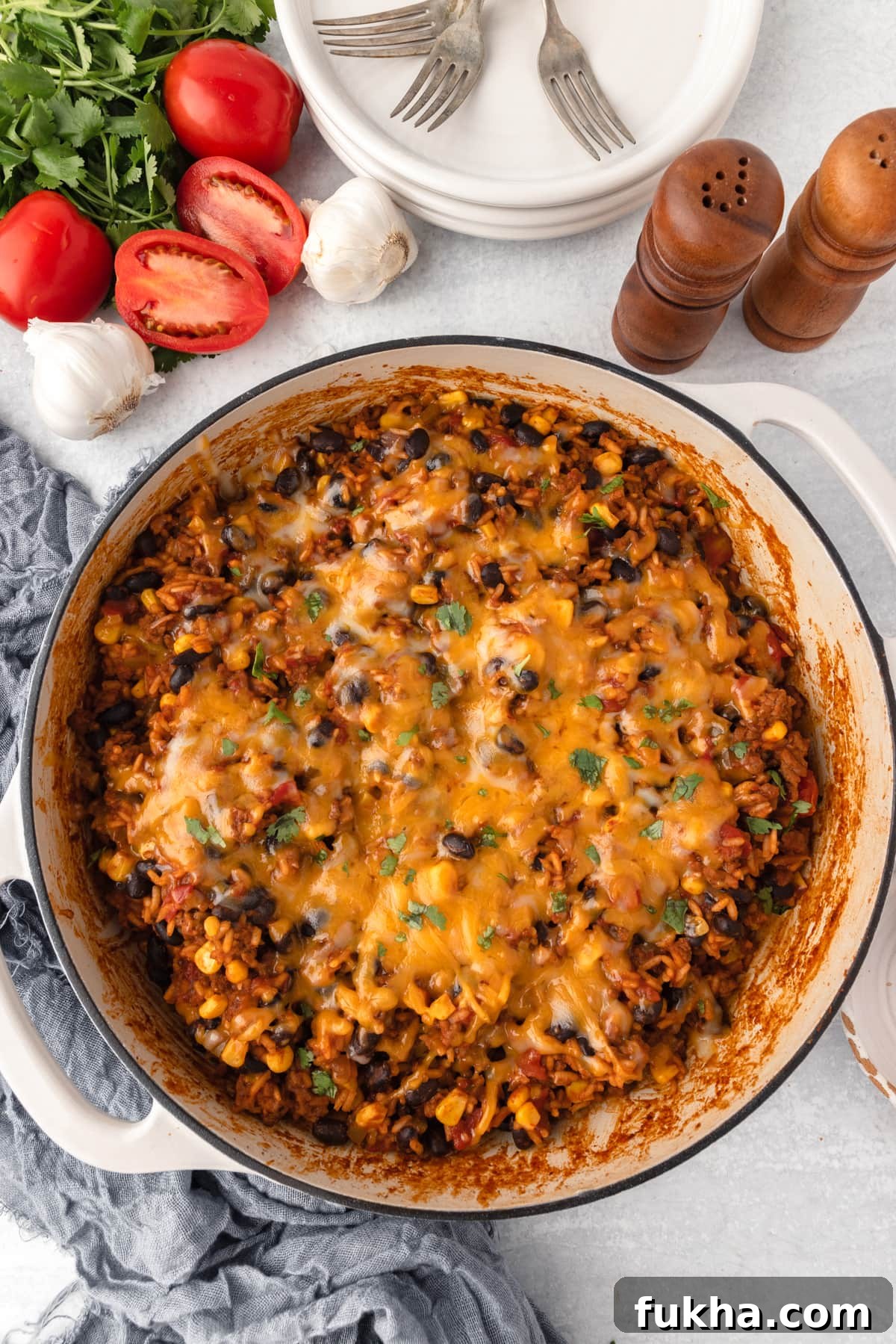 Finished Mexican beef and rice with melted cheese and cilantro.