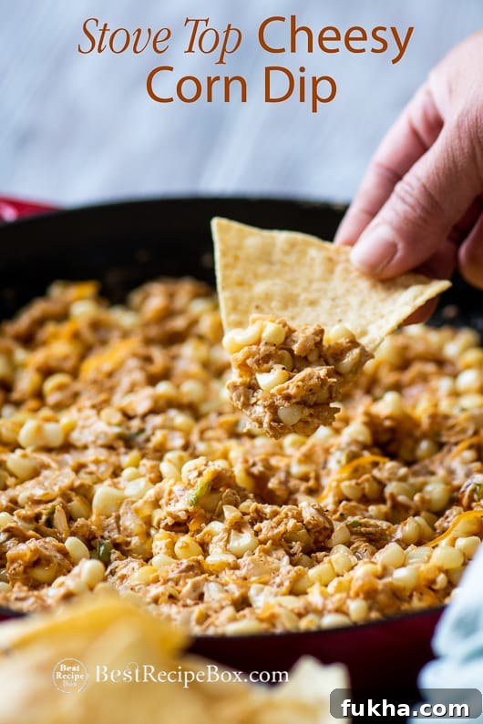 Stove Top Cheesy Corn Dip in a casserole served with chips