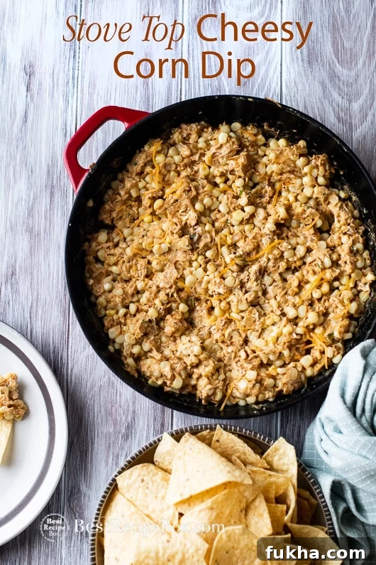 Stove Top Cheesy Corn Dip with chips in a casserole