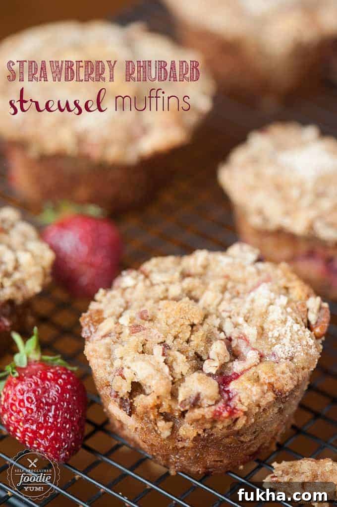 Strawberry Rhubarb Muffins with Pecan Streusel Topping on rack