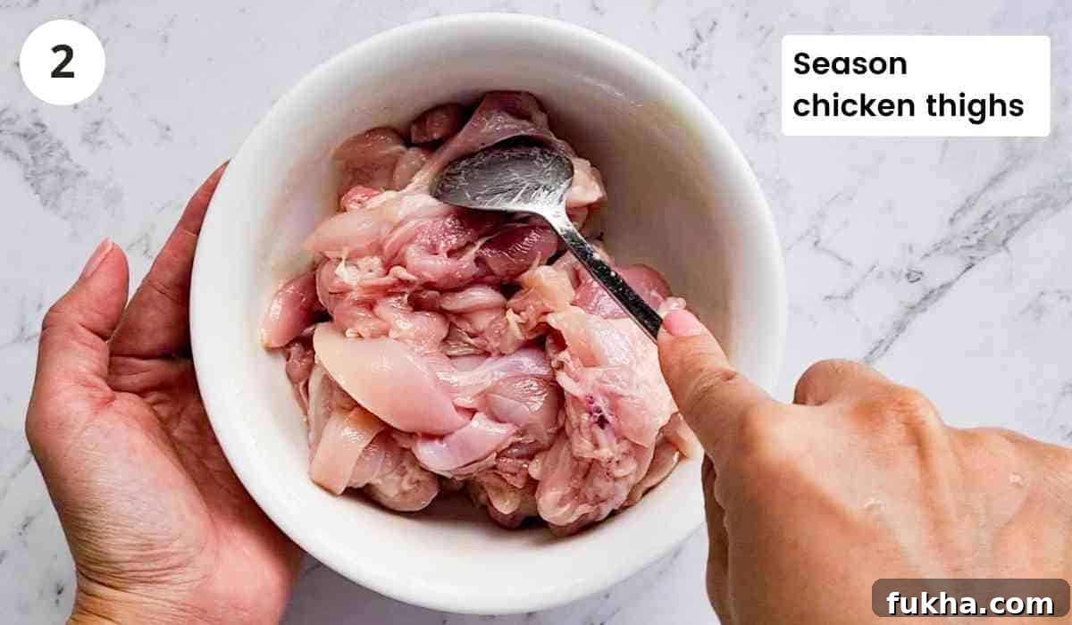 Chicken being mixed in seasoning