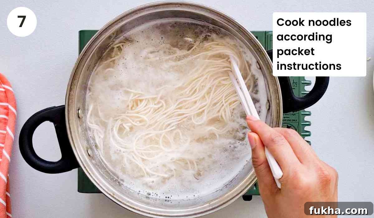 noodles being cooked in a pot of water