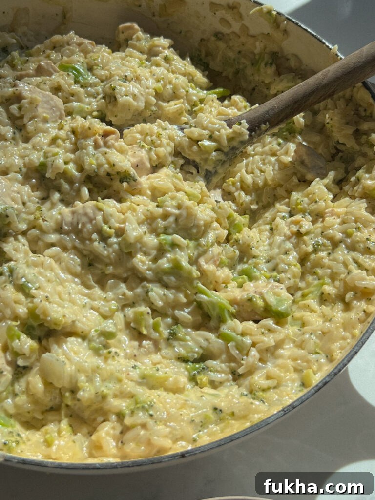 Cheesy rice with broccoli and chicken in a skillet