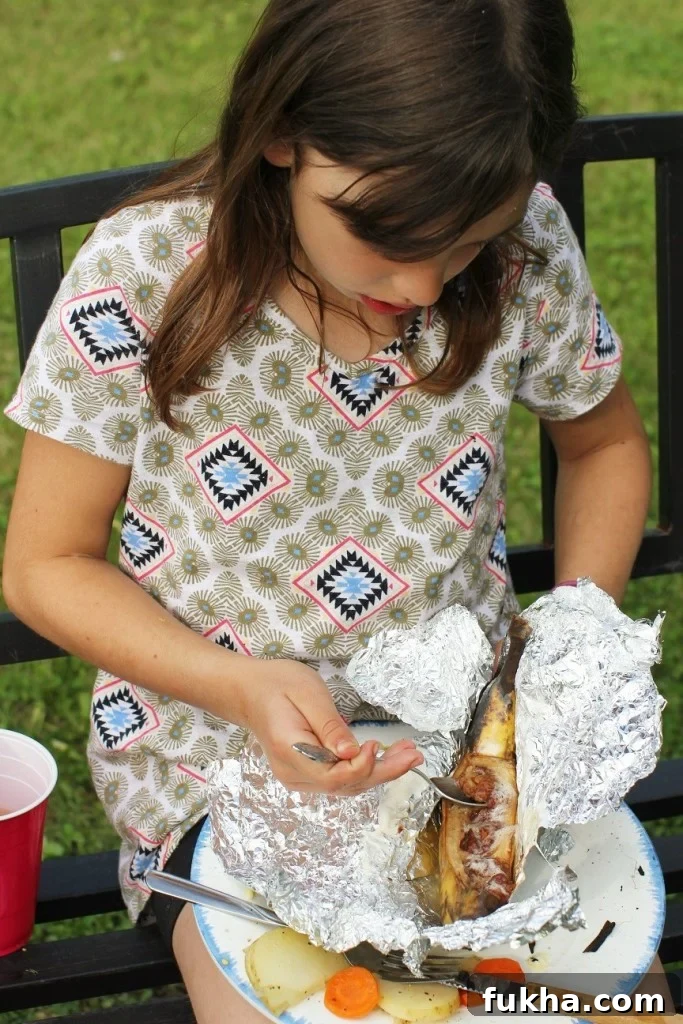 Campfire Banana Boat Recipe for Kids 2 Meredith eating banana boats cooked over the campfire