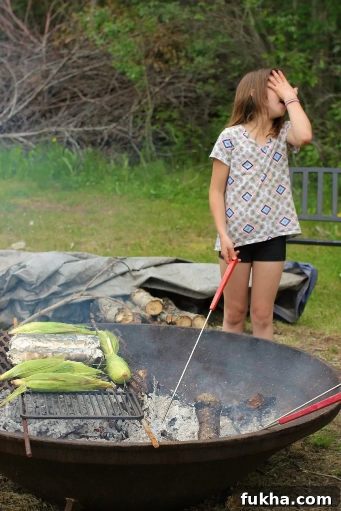 Campfire Banana Boat Recipe for Kids 7 Corn cobs and foil packets roasting
