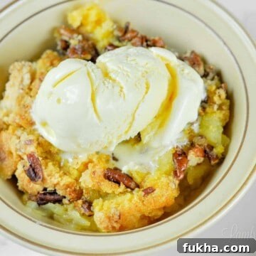 bowl of pineapple dump cake with ice cream.