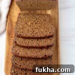 Kavring bread sliced on a wooden cutting board.