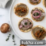 Crackers topped with Vegetarian Mushroom Pâtë and pickled shallots and mustard seeds.