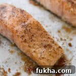 Close up of Baked Salmon with Butter and Brown Sugar on a baking sheet.