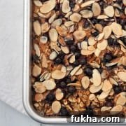 Baked oat and rye porridge with blueberries and almonds in a pan