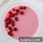 Close up of an overhead shot of Lingonberry Mousse topped with frozen lingonberries.