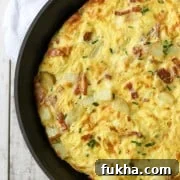 Danish egg cake in a pan sitting on a kitchen towel