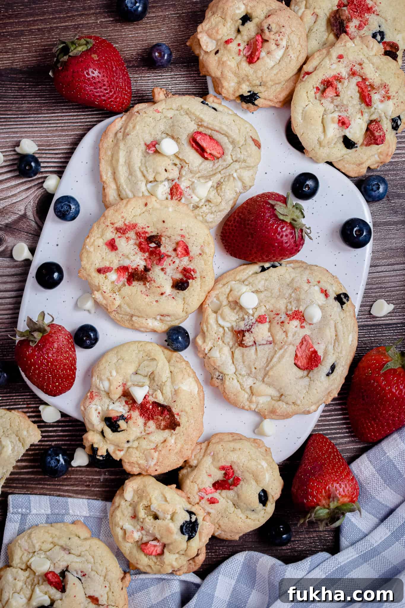 An overhead shot of red white and blue cookies on a cutting board