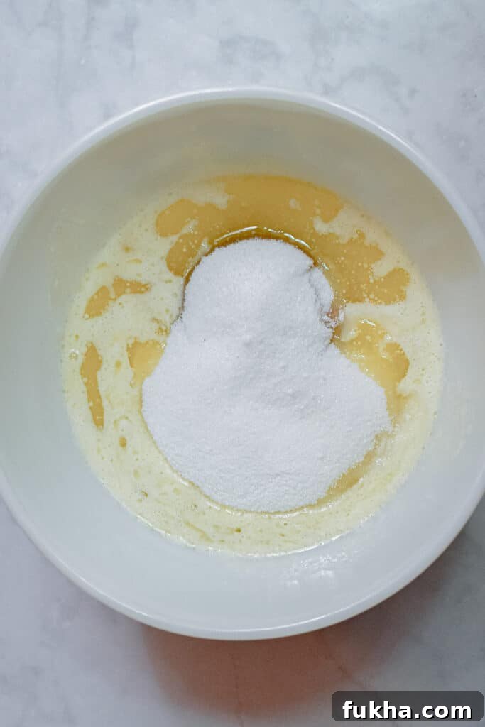 The melted butter and sugar are creamed together.