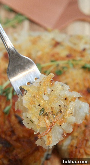 A bite of crispy shredded potatoes perfectly seasoned.