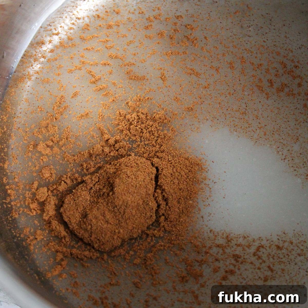 Sugar, cinnamon, and water in sauce pan ready to bring to a boil for the candied almonds.